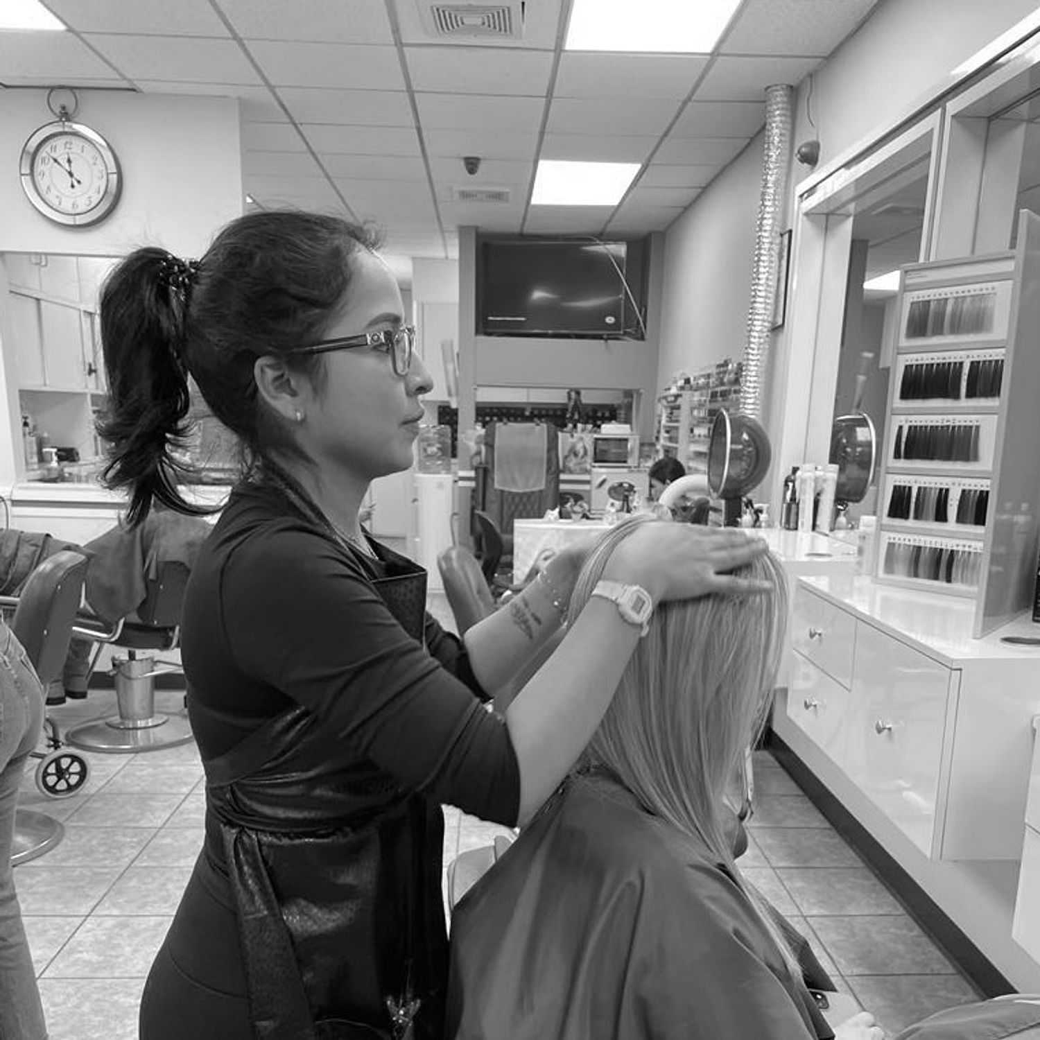 Portrait of Samantha, a professional stylist at Hairitage Unisex, showcasing their expertise and style.