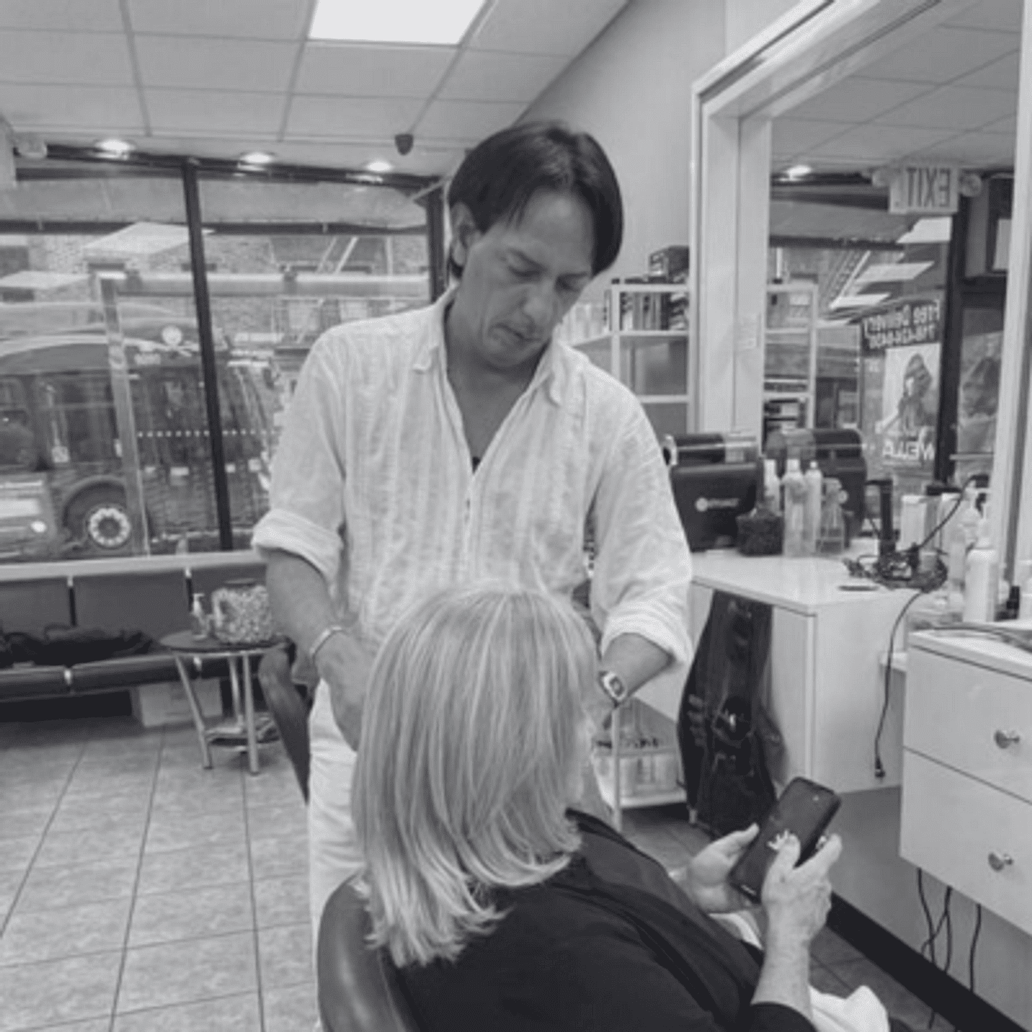 Portrait of Ishmael, a professional stylist at Hairitage Unisex, showcasing their expertise and style.