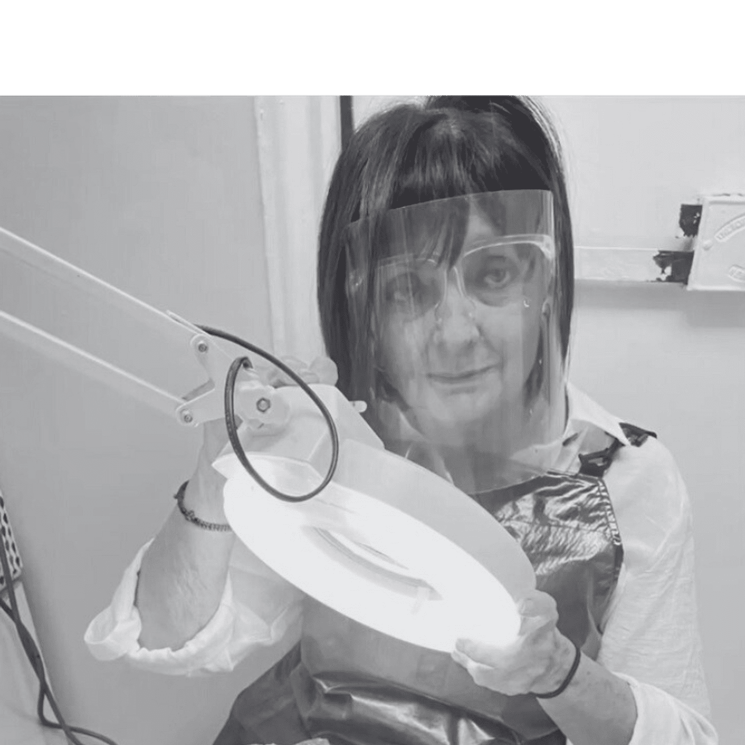 Portrait of Angela, a professional stylist at Hairitage Unisex, showcasing their expertise and style.