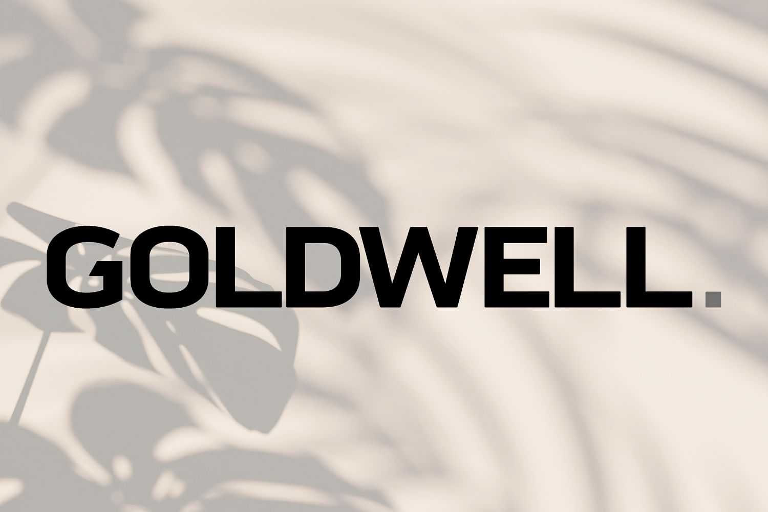 Text "GOLDWELL." overlaid on a background with shadows of leaves on a light surface.