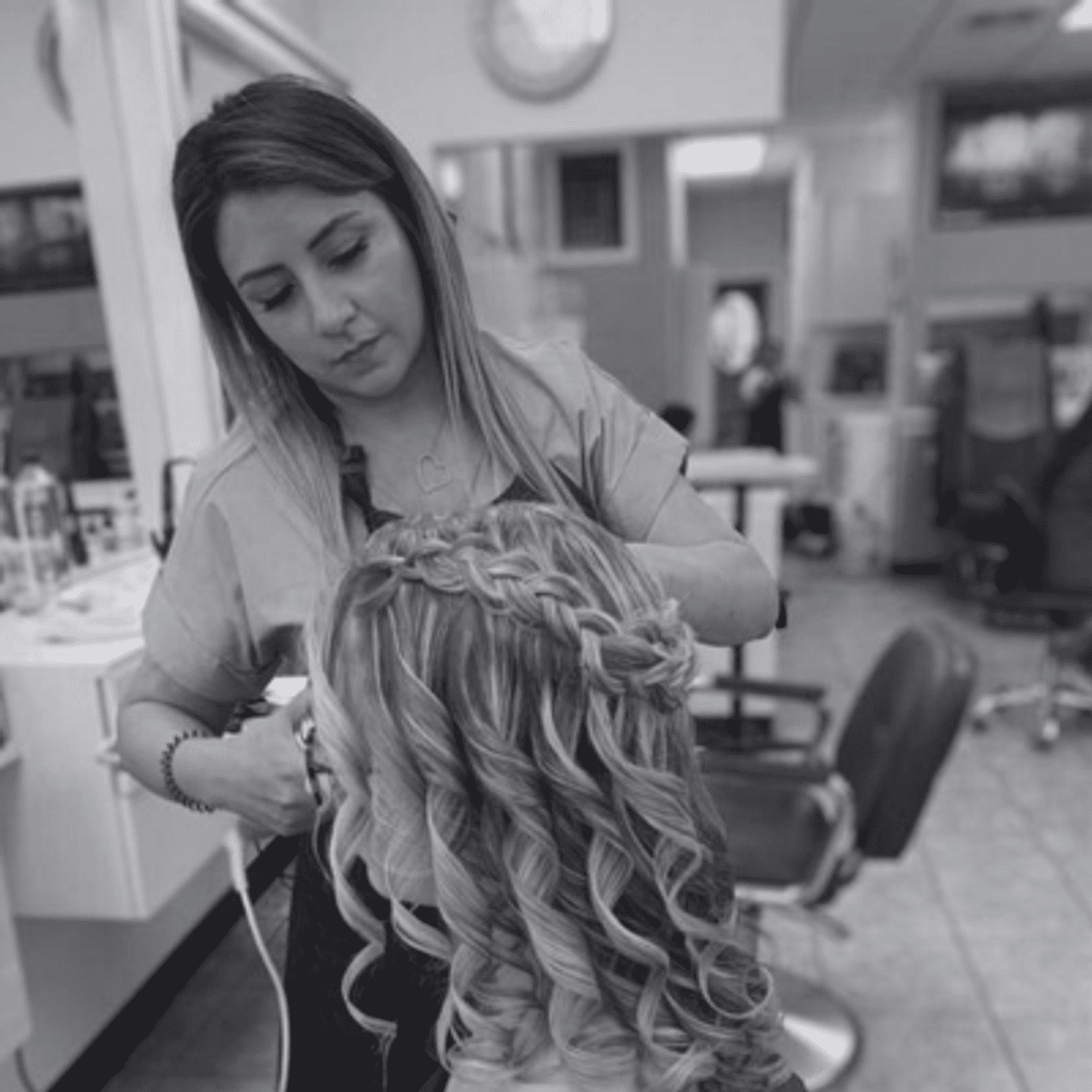 Portrait of Mercy, a professional stylist at Hairitage Unisex, showcasing their expertise and style.